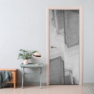 Αυτοκόλλητο πόρτας Πύργοι της Πόλης — ασπρόμαυροι ουρανοξύστες που υψώνονται ο ένας πίσω από τον άλλο, τοποθετημένο σε πόρτα